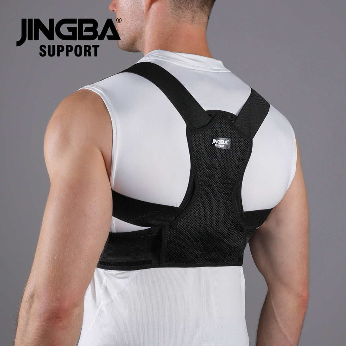Person wearing a black posture corrector with 'JINGBA SUPPORT' branding on a gray background.