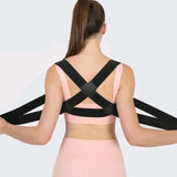 Woman wearing a black posture corrector on a light gray background - Adjustable Posture Corrector for Back & Shoulder Support - SASKA - Saska.ae