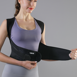 Woman wearing a black shoulder brace with a gray background